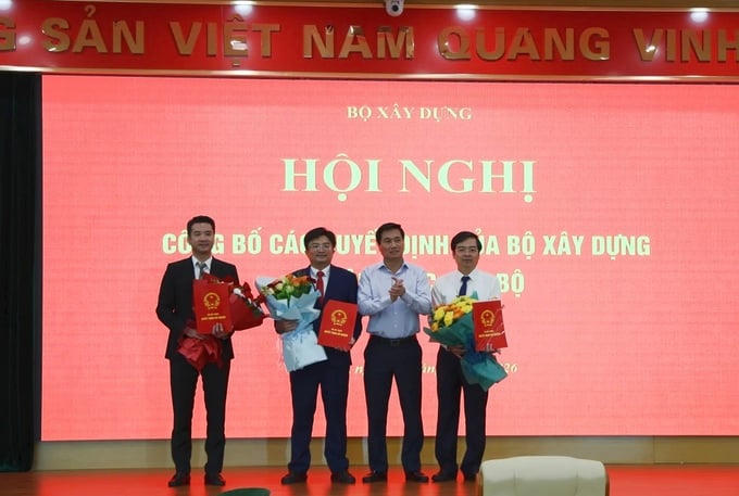 Thứ trưởng Nguyễn Tường Văn trao Quyết định và tặng hoa chúc mừng các cán bộ mới được bổ nhiệm. Ảnh: Bộ Xây dựng